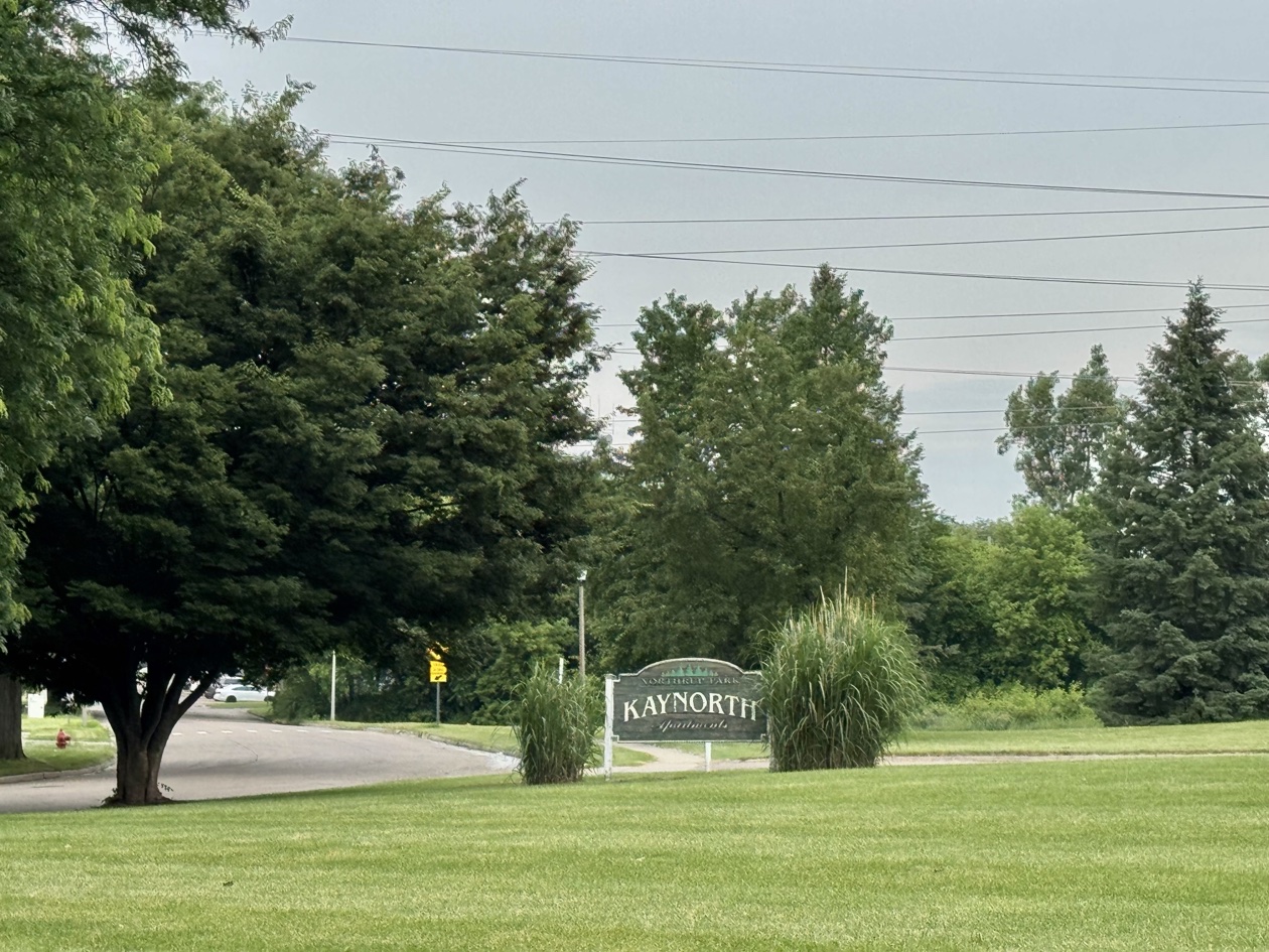 Kaynorth Apartments entrance sign on a landscaped lawn in front of the buildings