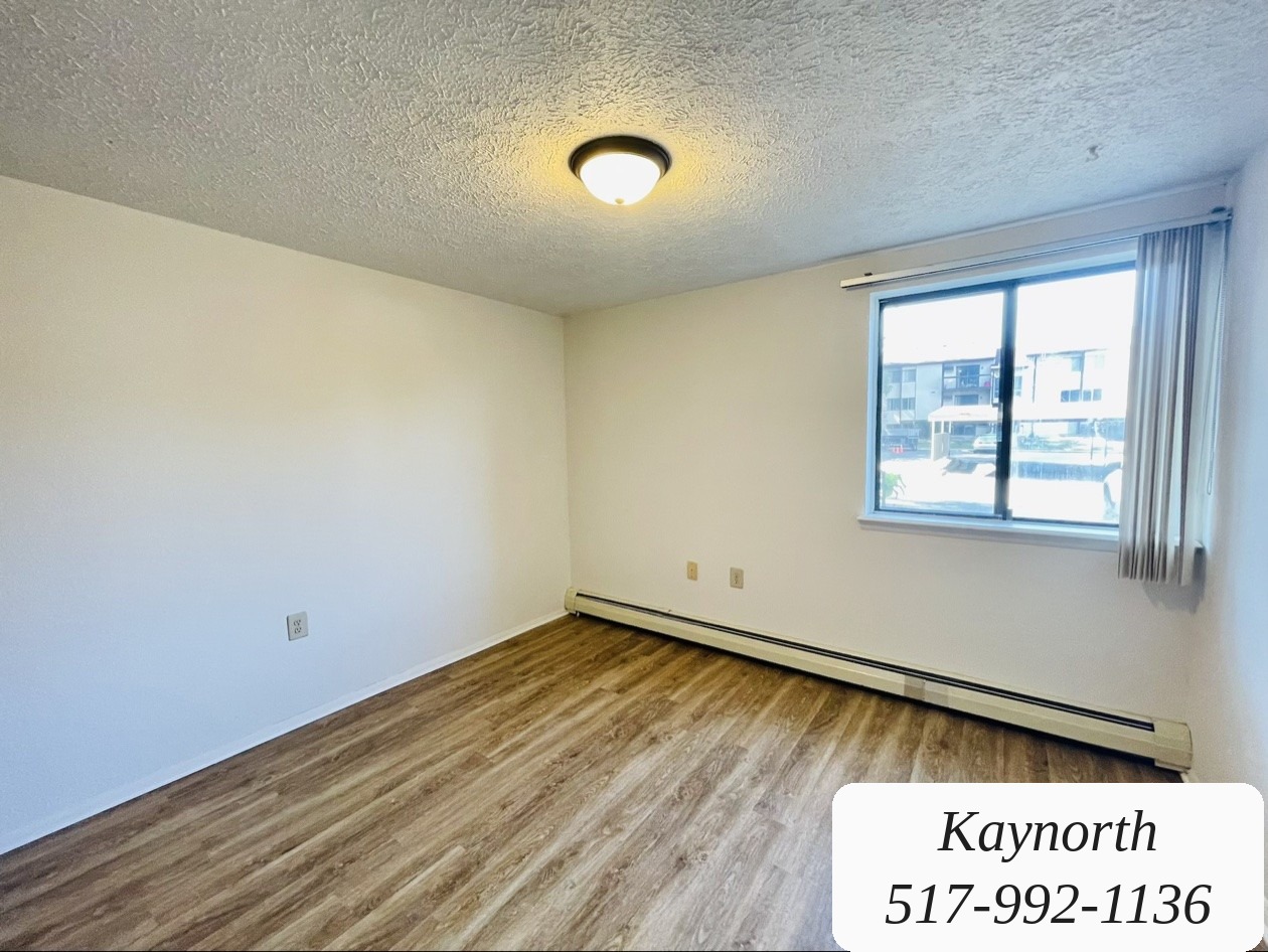 Bedroom with a large window in a Kaynorth apartment