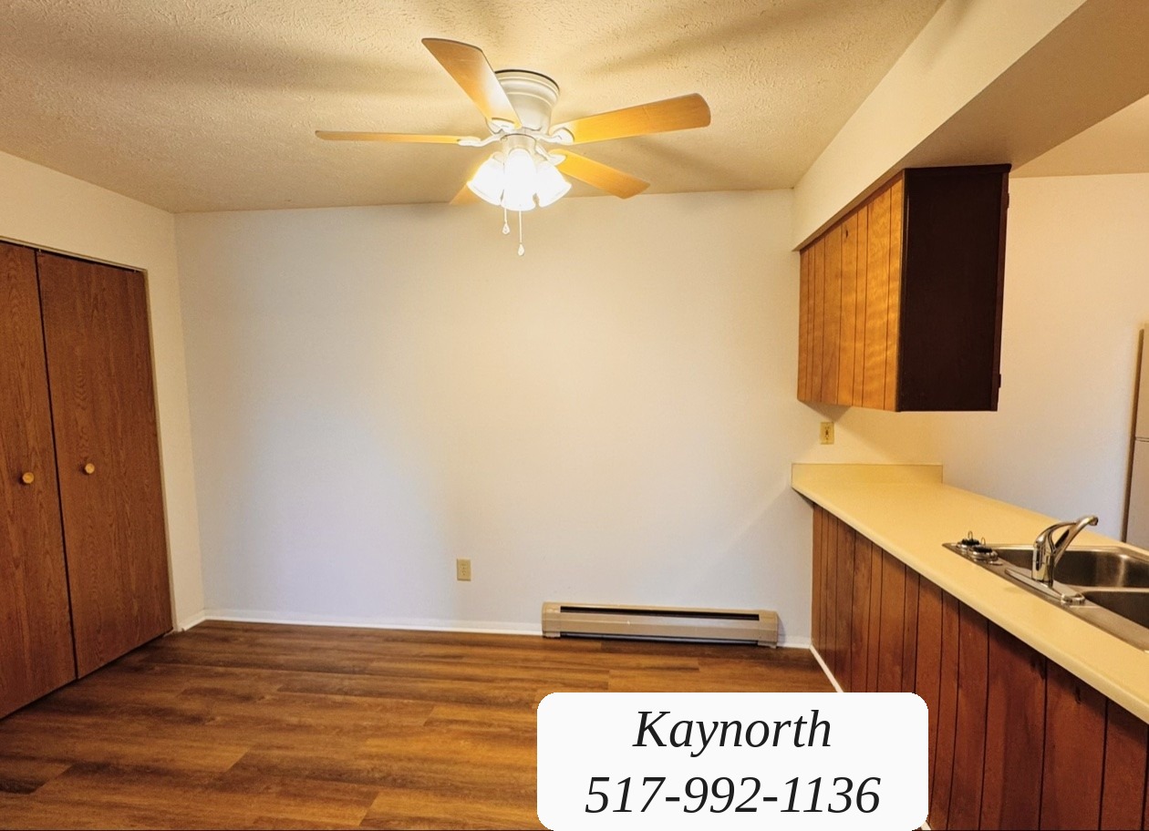 Dining area with a ceiling fan next to the kitchen in a Kaynorth apartment