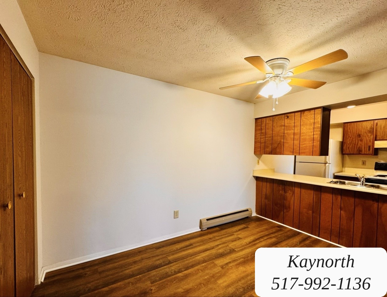 Open living and dining area with the kitchen beyond in a Kaynorth apartment