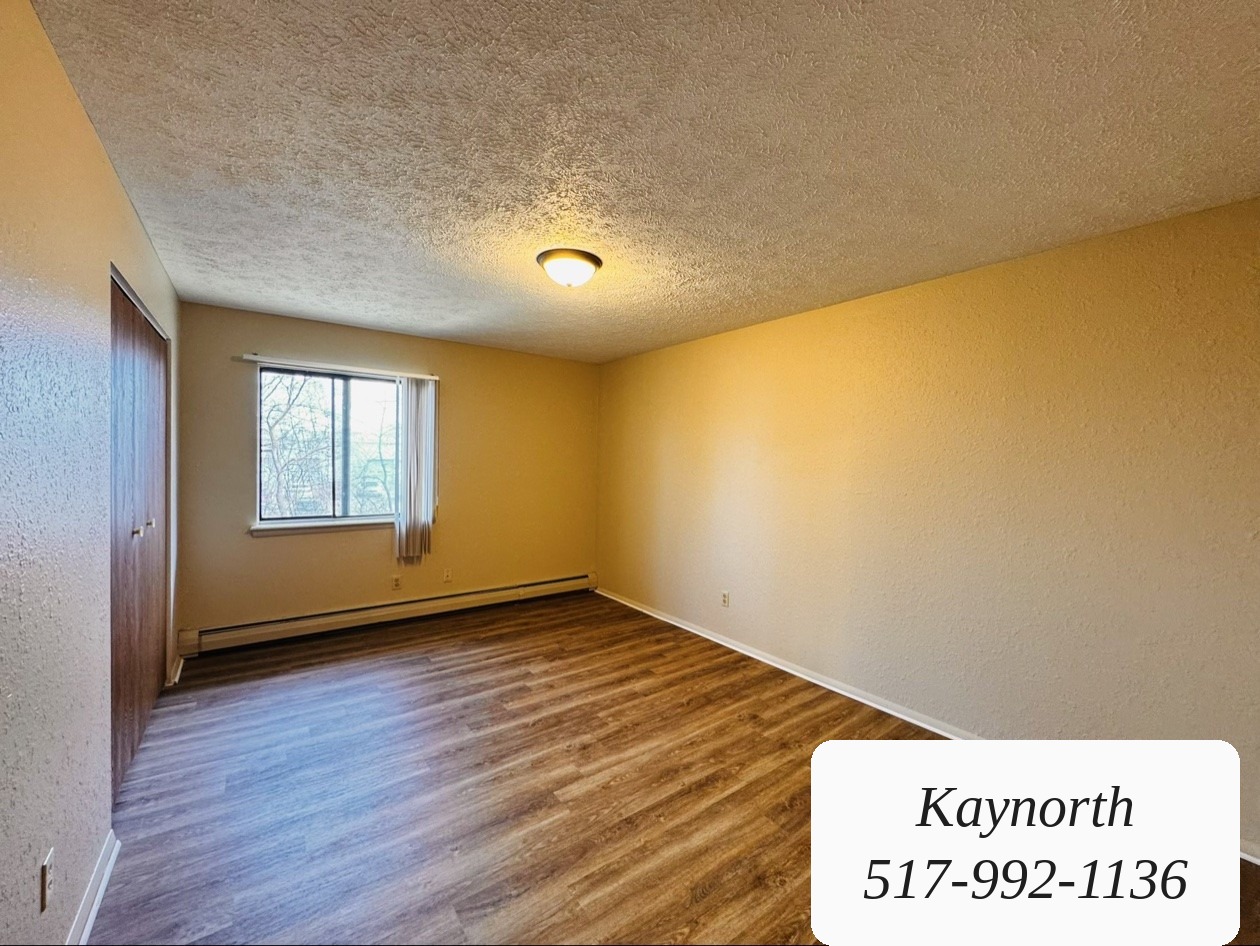 Bedroom with warm walls and a window in a Kaynorth apartment