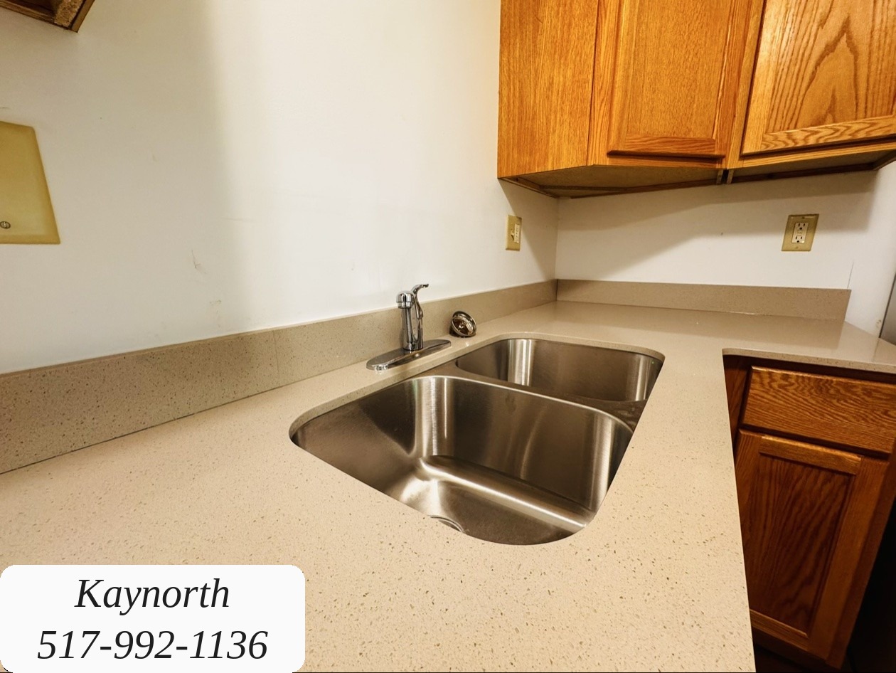 Double stainless-steel kitchen sink and countertops in a Kaynorth apartment