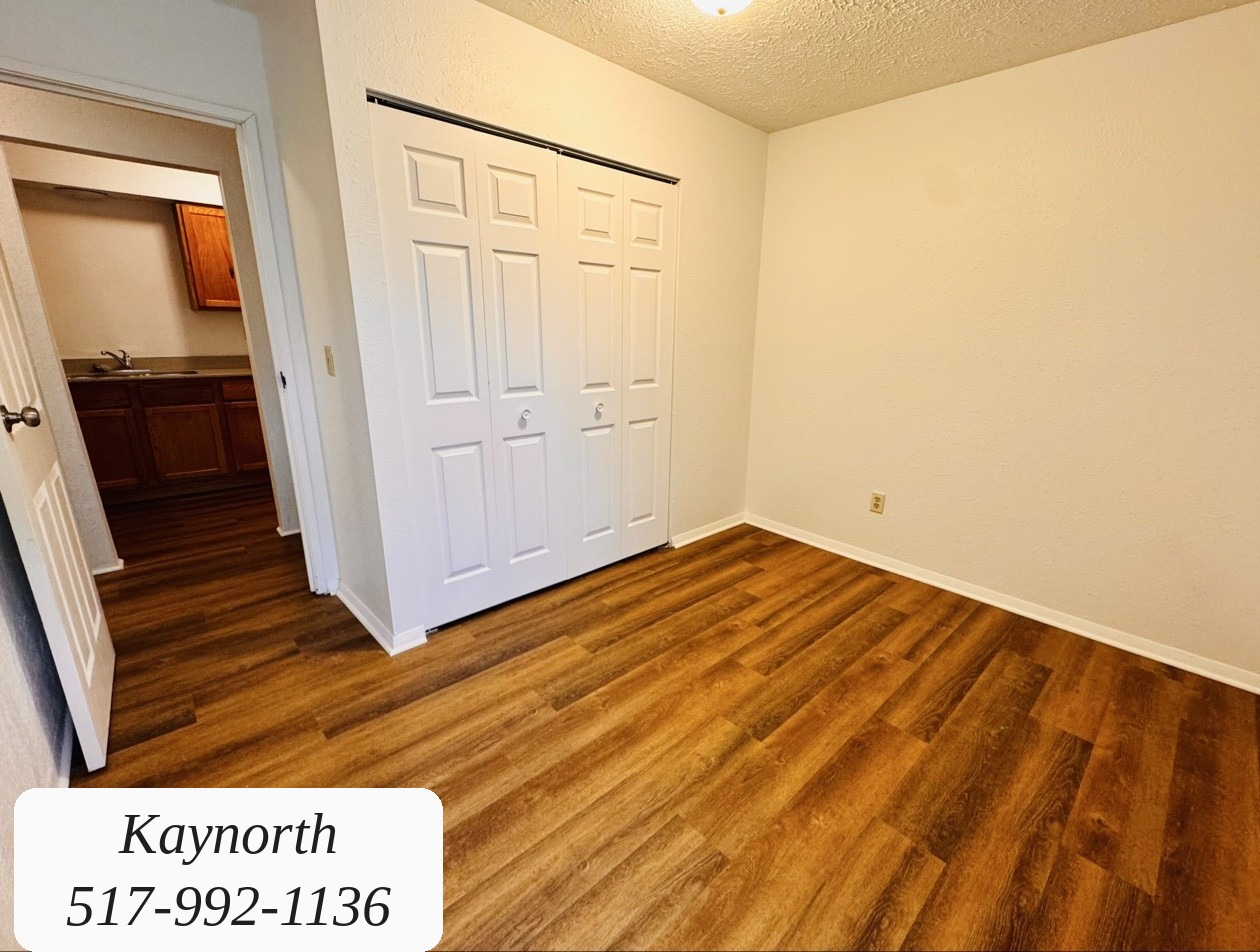 Bedroom with sliding closet doors in a Kaynorth apartment